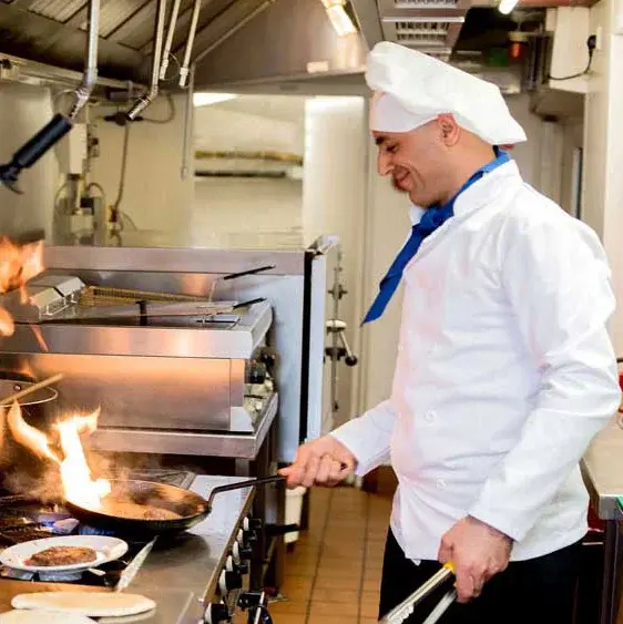 Paloma Landing Chef Created Meals, chef frying a dish.