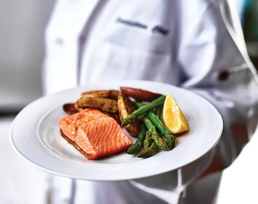 Paloma Landing Chef Created Meals, chef delivering a finished dish.