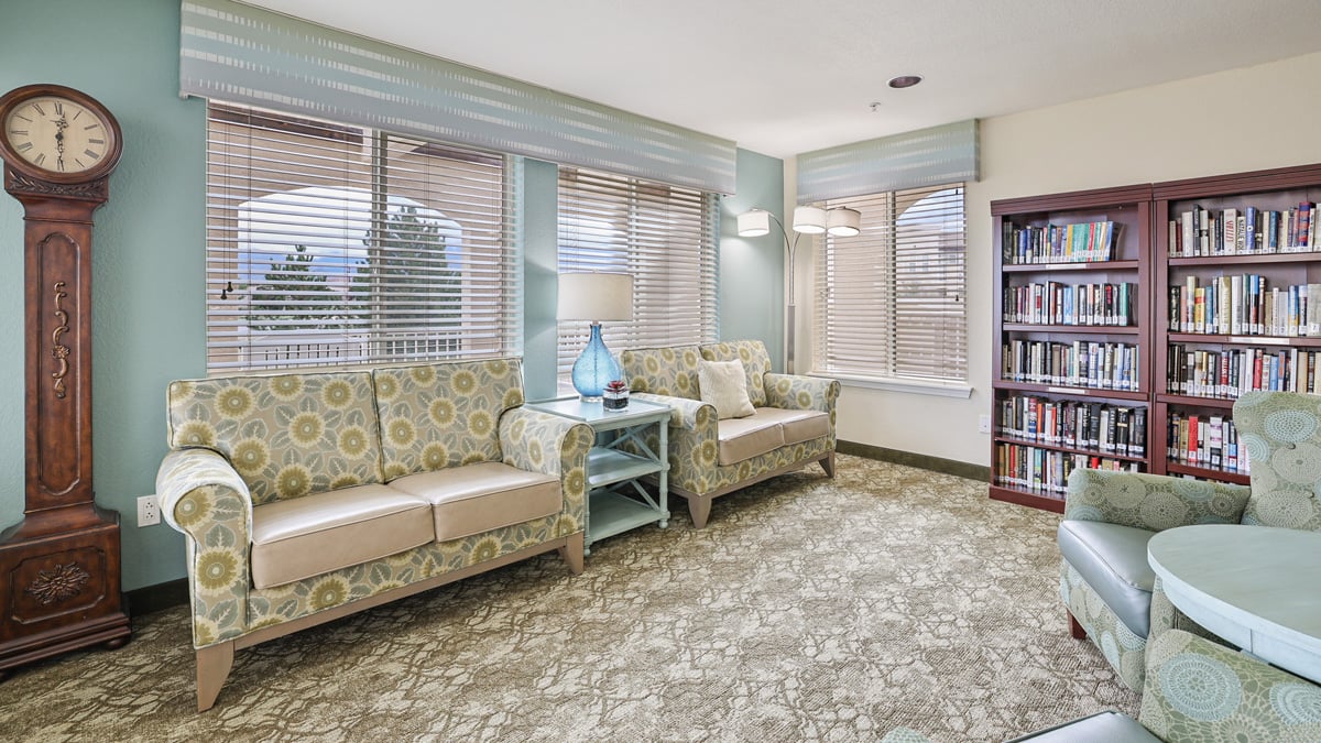 The library at Paloma Landing with shelves of books and comfortable seating